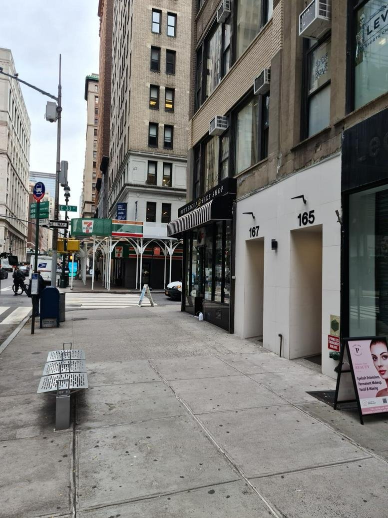 Exterior entrance of 167 Madison Ave Suite with street view and surrounding buildings.