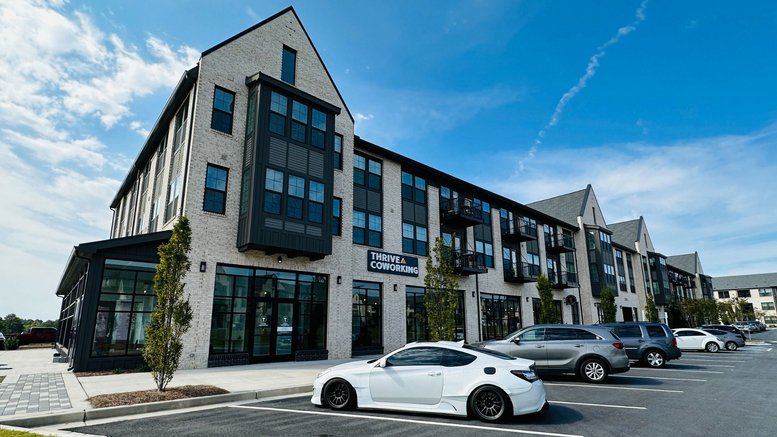 Exterior view of the modern stone and glass facade building at 2100 Westshore Drive, Cumming, Georgia.