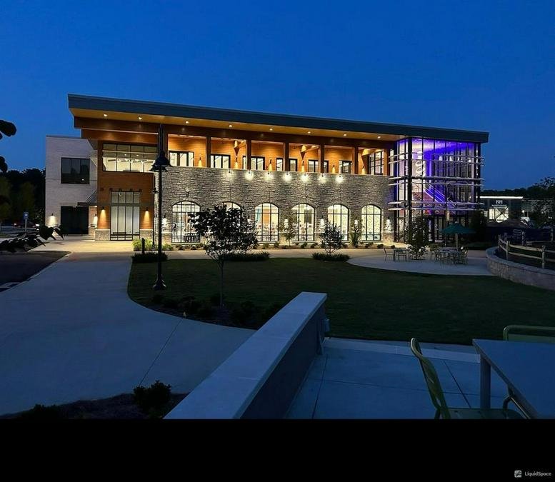 Exterior night view of the modern stone and glass building at 2245 Wisteria Drive SW.