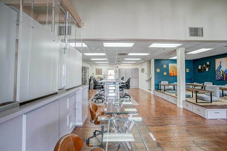 Lobby view at 25433 Narbonne Avenue looking toward an open-plan coworking area with blue walls.