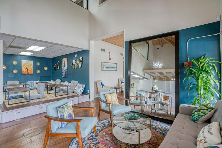 Spacious communal lounge at 25433 Narbonne Avenue featuring blue accent walls and stylish seating.