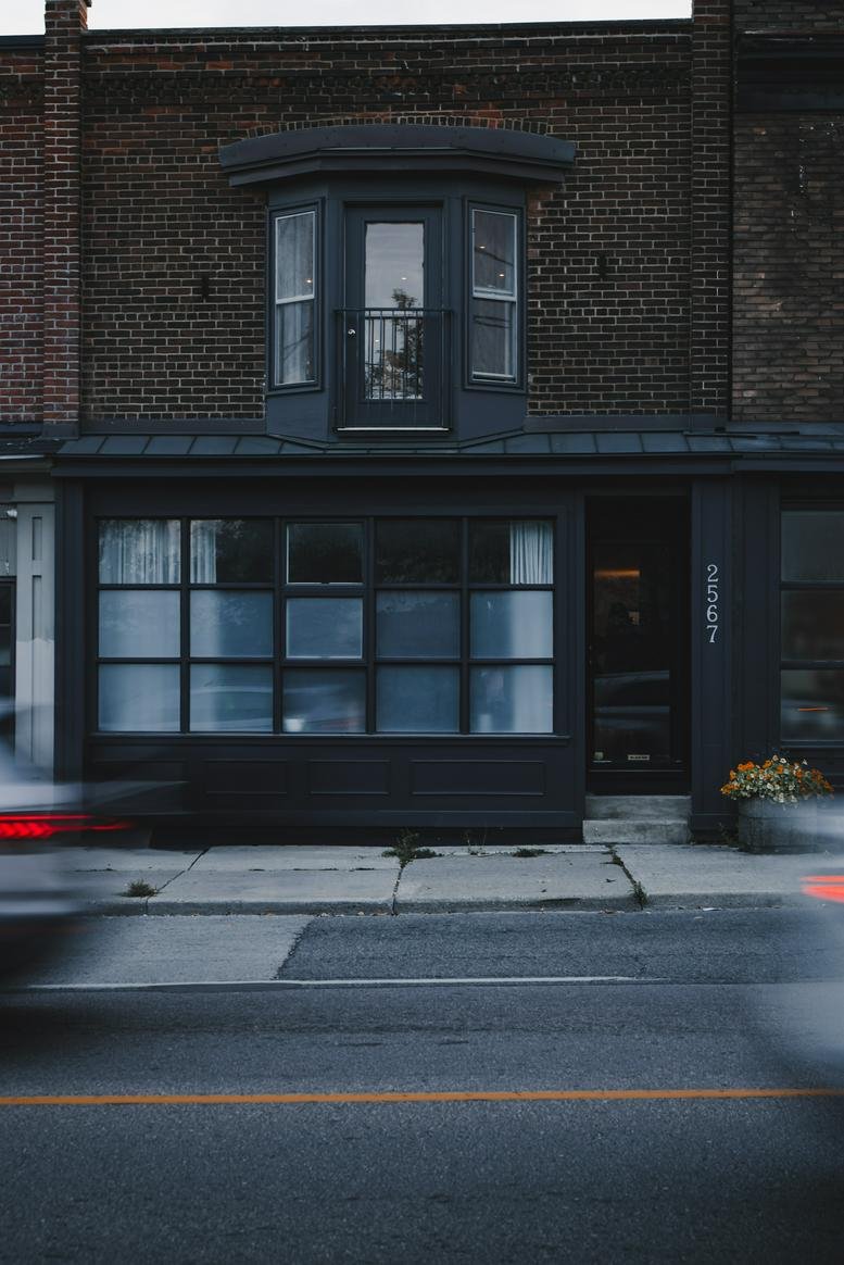 Exterior facade of the brick building at 2567 Dundas St W, Toronto, Ontario.