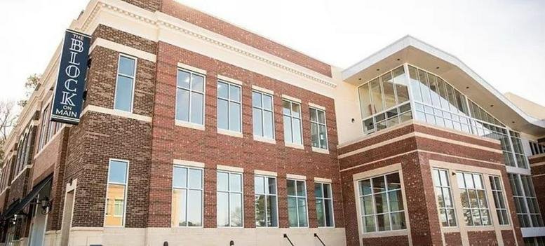 Exterior view of the brick and glass building at 300 S Main Street, Suite 212, Holly Springs.