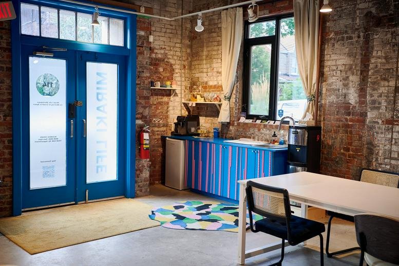 Blue-framed entrance at 35 Golden Avenue, 114 with a colorful striped kitchenette nearby.