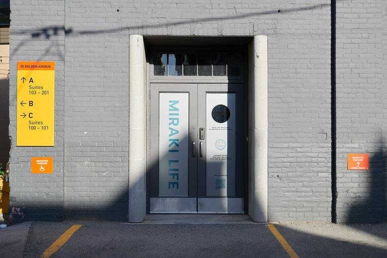 Exterior view of the grey brick building entrance at 35 Golden Avenue.