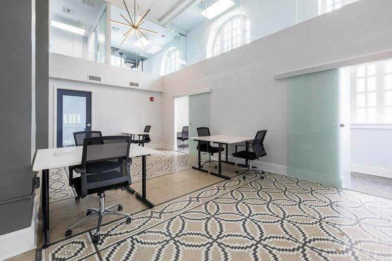 Spacious common area at 37 N. Orange Avenue with geometric tile flooring and a mezzanine level.
