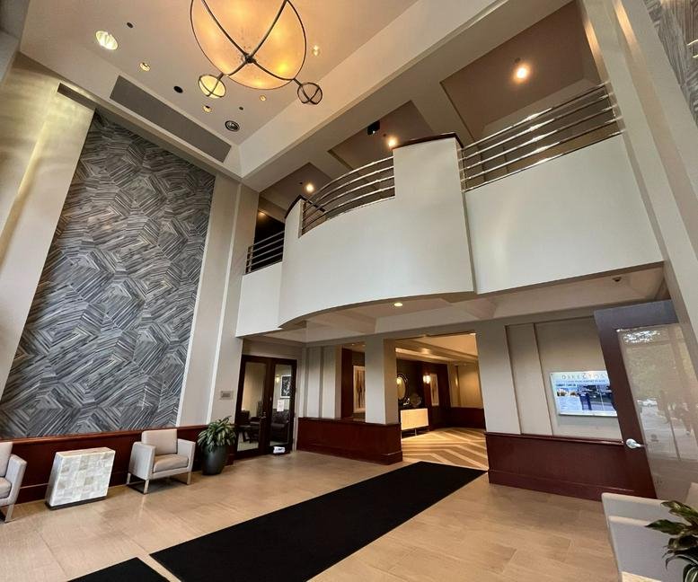 Grand lobby and reception area at 4200 Parliament Place with high ceilings and a textured feature wall.