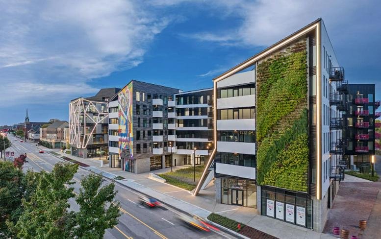 Exterior of the modern apartment and office building at 470 W Broad Street with a large vertical green living wall.