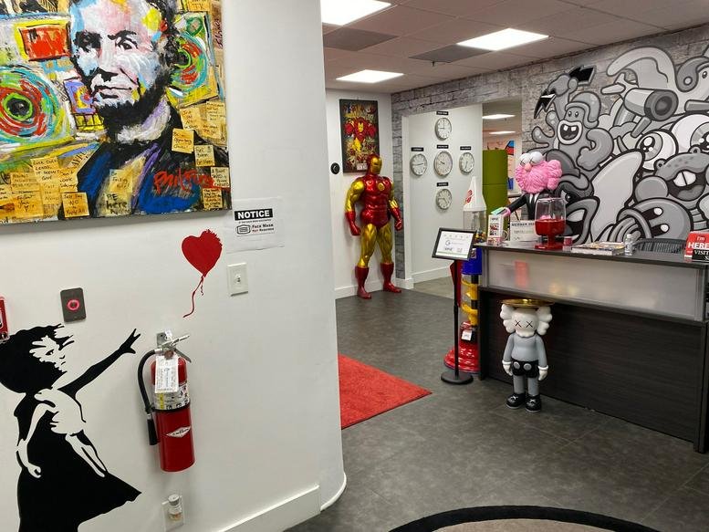 Colorful reception area at 4800 N Federal Highway, Suite B200 featuring pop art and life-size character figures.