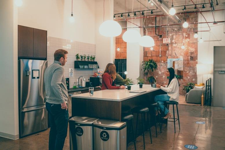 Spacious communal kitchen and lounge at 600 West Jackson Boulevard with modern lighting and a large island.