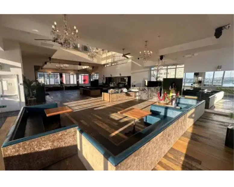 Spacious communal lounge at 617, West 46th Street, 6 fl with chandeliers and natural light.