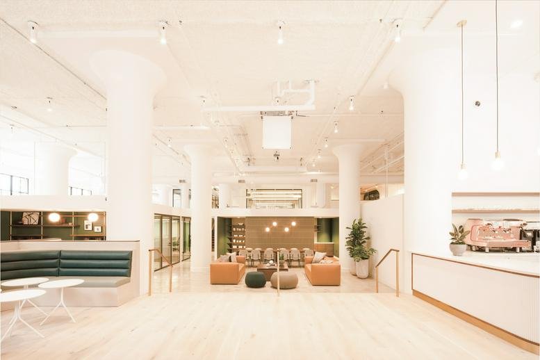 Spacious, sun-drenched lobby at 630 NW 14th Avenue with double-height ceilings and modern furnishings.