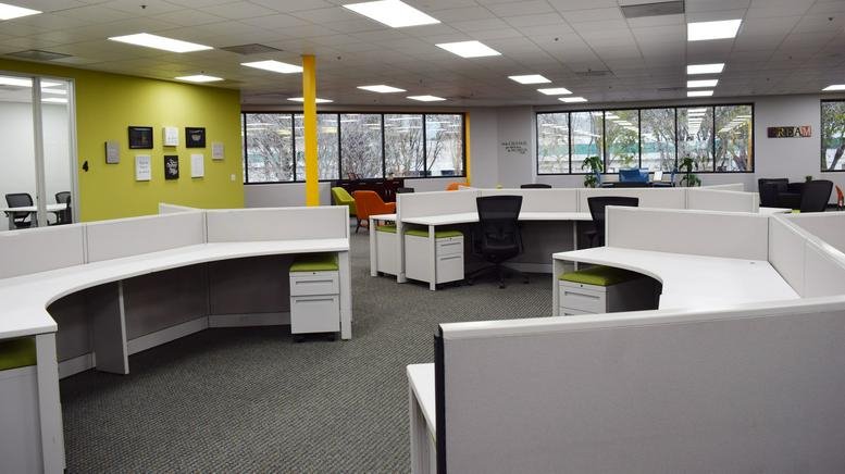 Spacious open-plan workspace at 691 South Milpitas Boulevard, Suite 217, with modern curved desks.