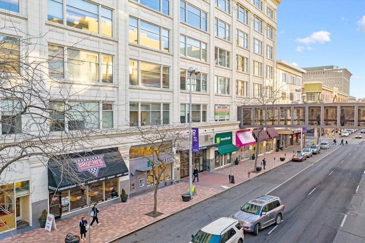 Exterior view of the classical stone building at 707 W. Main Avenue, Suite B1.