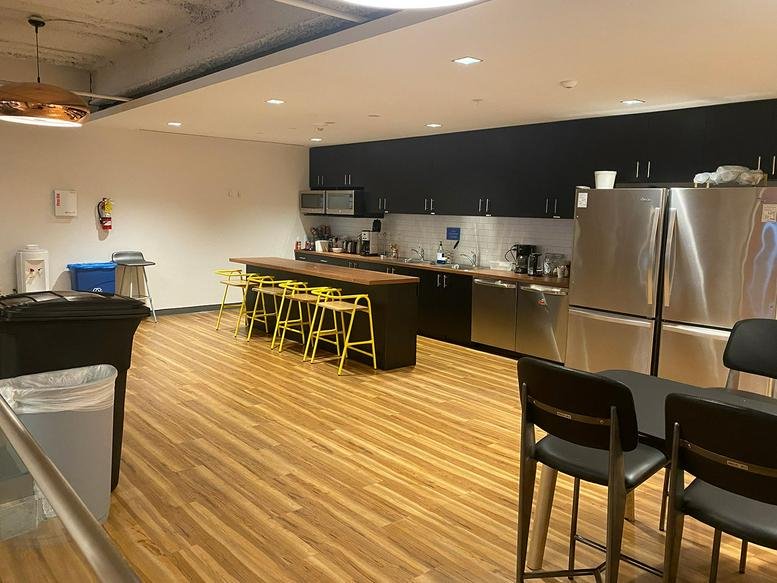 Spacious modern kitchen and breakroom at 740 15th Street North West with wooden floors and a large island.