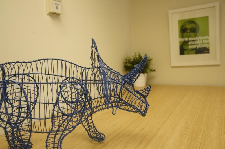 Reception area at 800 Grant Street, Suite 110 and 310 featuring a blue wireframe triceratops sculpture.