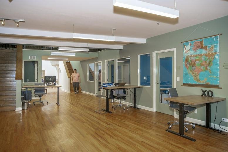Bright open-plan workspace at 805 Greenwood Street, Dempster with wood floors and a wall map.
