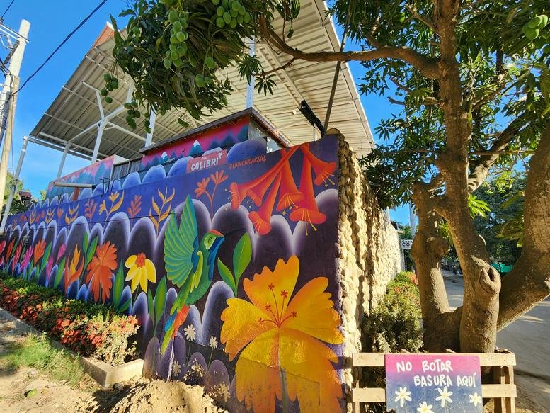 Exterior view of the colorful mural and sheltered patio at CRA 6, 2A-19, Palomino, Dibulla, La Guajira.