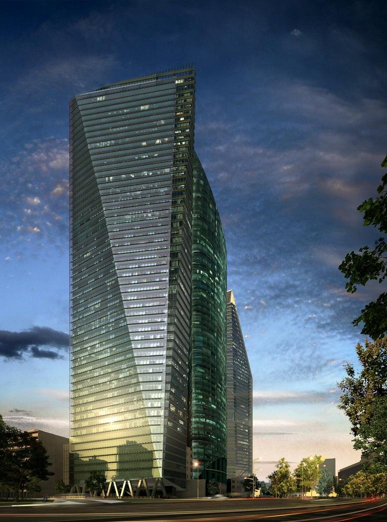 The glass exterior of the Paseo de la Reforma 509 building against a blue twilight sky.
