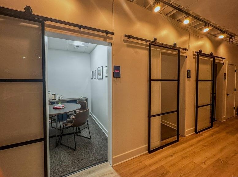 Hallway at The Law Building, Black Wall Street, Durham with modern glass sliding office doors.