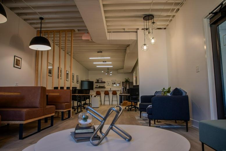 Stylish lounge area at The Law Building, Black Wall Street, Durham with leather booths and blue velvet chairs.