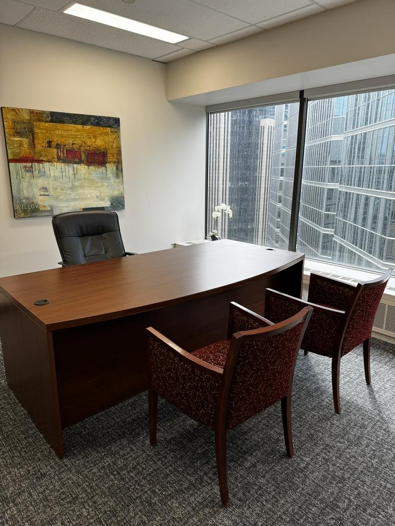 Bright private office at 155 University Avenue, Suite 1800 with a wooden desk and city views.