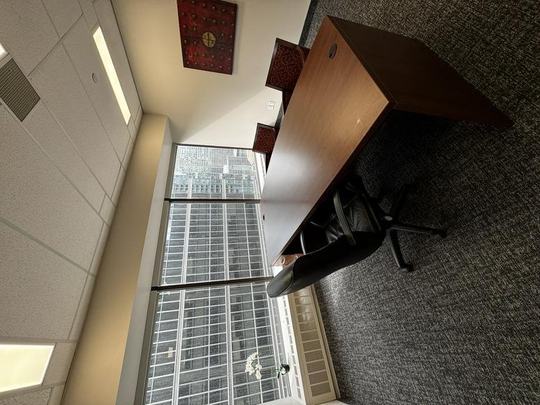 Contemporary office at 155 University Avenue, Suite 1800 featuring a wood desk and skyline views.