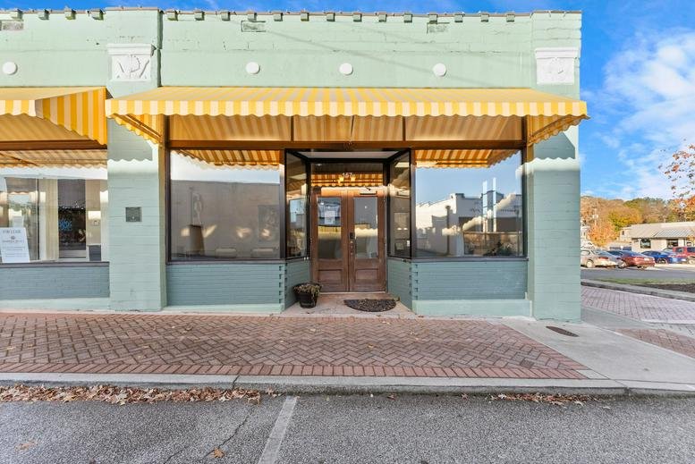 Exterior storefront of Modern Cowork Toccoa, Downtown Toccoa, Georgia with a yellow striped awning.