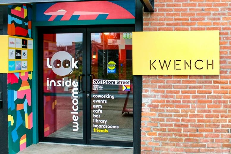 Exterior entrance of KWENCH, 2031B Store Street, with colorful graphics and yellow signage.