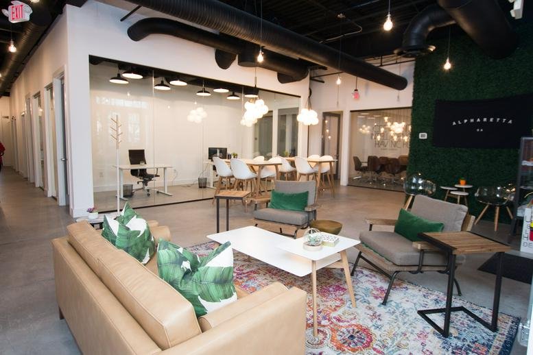 Spacious communal lounge at 44 Milton Avenue, Alpharetta, Ga 30009, with mid-century modern furniture and plants.