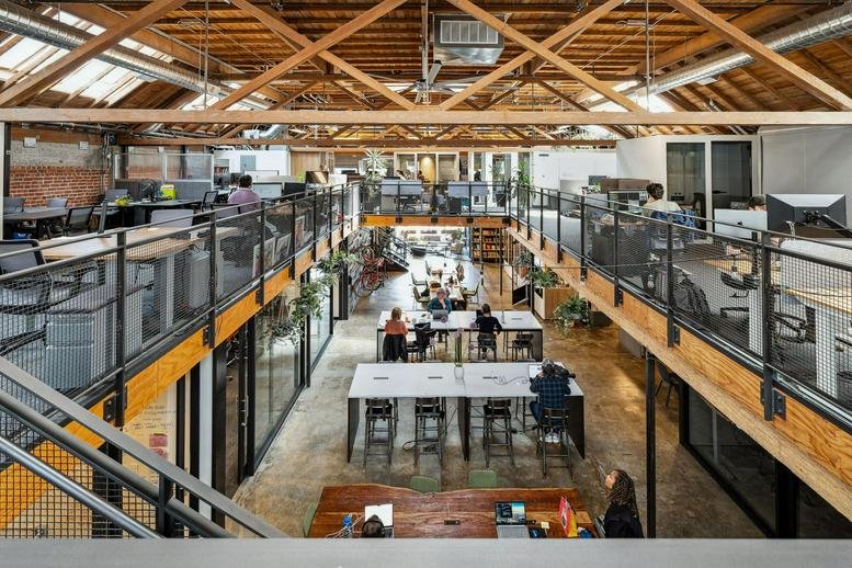 Spacious bi-level coworking hub at 490 43rd Street, Temescal District, Oakland, California with wood ceilings.