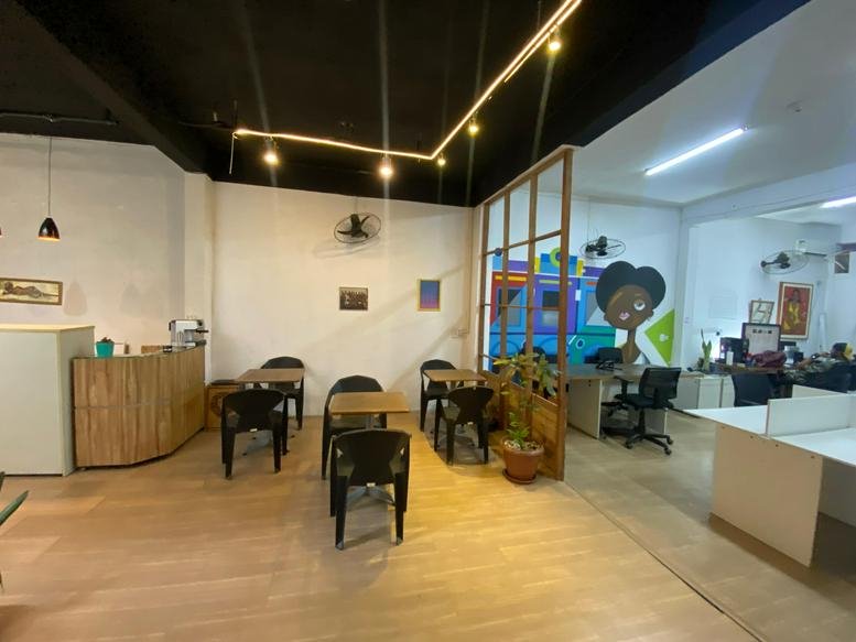 Spacious communal area with wooden floors and unique lighting at Da Praça Coworking, Rua Viscondessa de Pirassununga 59.