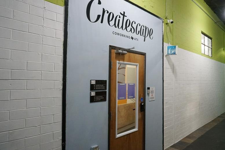 Office entrance at 701, Tillery Street No. 12, Austin, Texas with branded signage above a glass door.