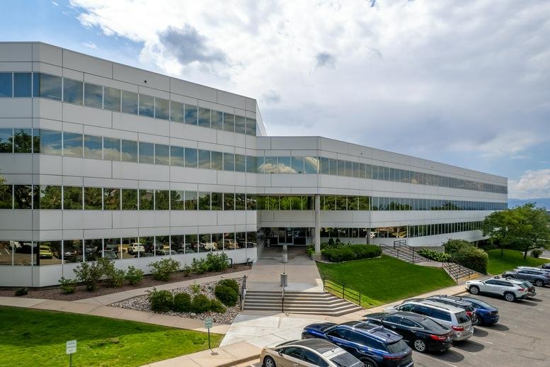 Exterior view of the multi-story glass and white facade at Denver Tech Center, Centennial.