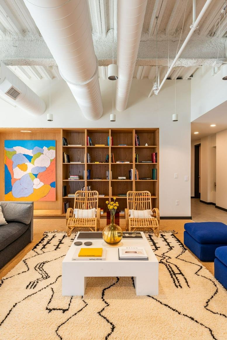 Spacious communal lounge at Financial House, 205 North Detroit Street with colorful art and a patterned rug.