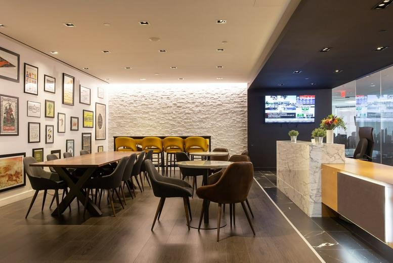 Modern reception area at 1 Adelaide St E with a marble desk and gallery wall.