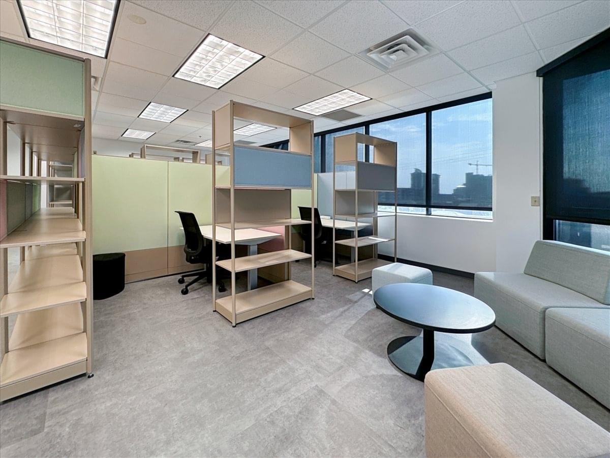 Modern open-plan workspace at 1 Music Circle, Suite 400 with modular desks and a grey lounge area.