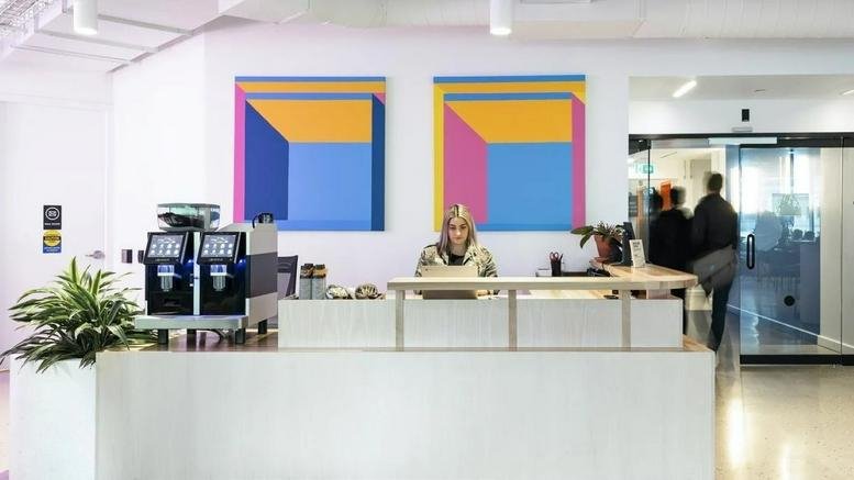 Reception area at 1 University Avenue featuring modern art and a high-end coffee machine.
