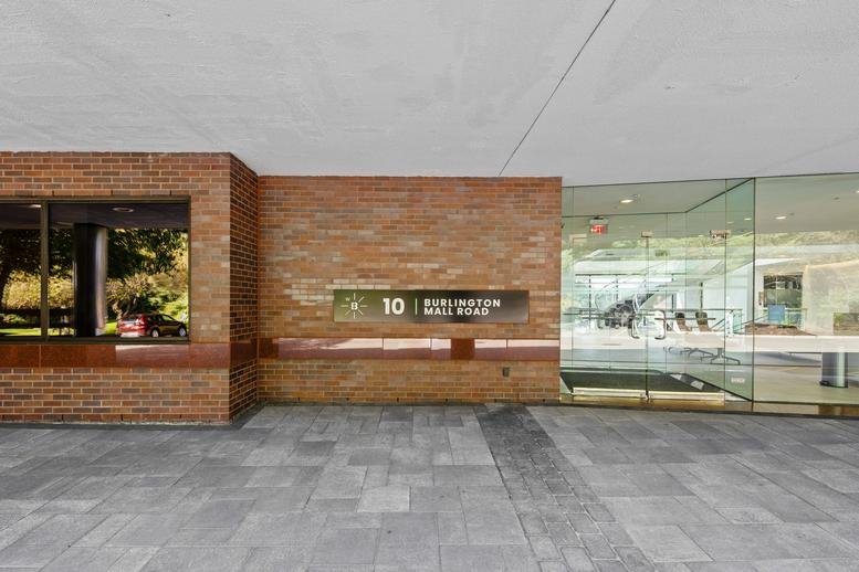 Building entrance with brick facade and glass doors at 10 Burlington Mall Road.
