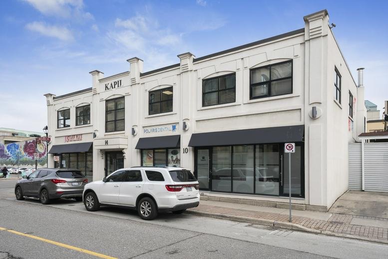 Exterior view of the white two-story commercial building at 10, George Street North, Brampton.