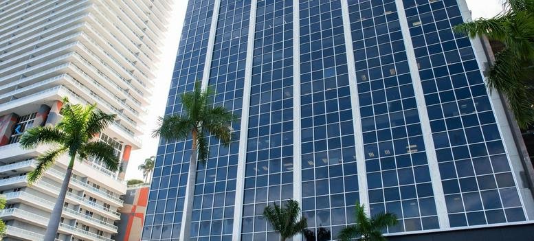 Exterior view of the glass-facade skyscraper at 100 Biscayne Boulevard, Miami, Florida.