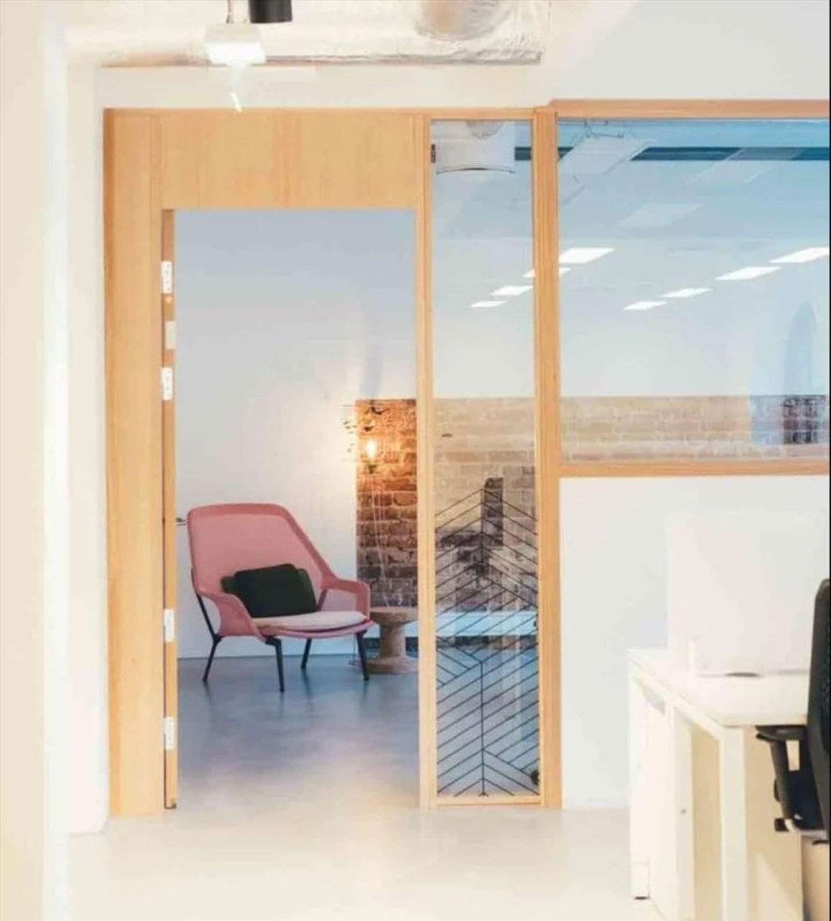 Bright private office entrance at 100 Northeast 5th Street, 1st Floor, Oklahoma City with a pink armchair.