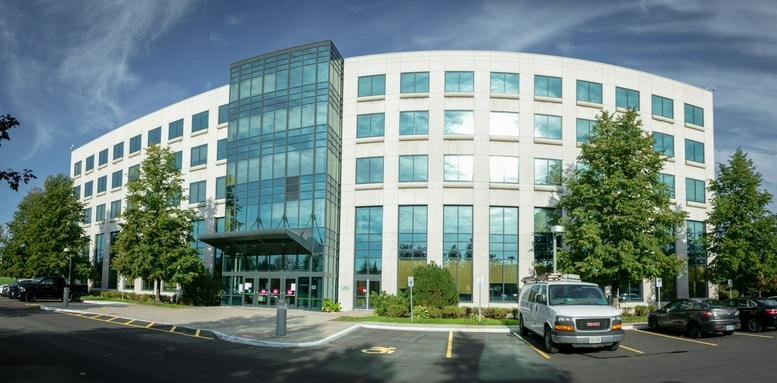 Exterior view of the contemporary glass and stone building at 1000 Innovation Drive.