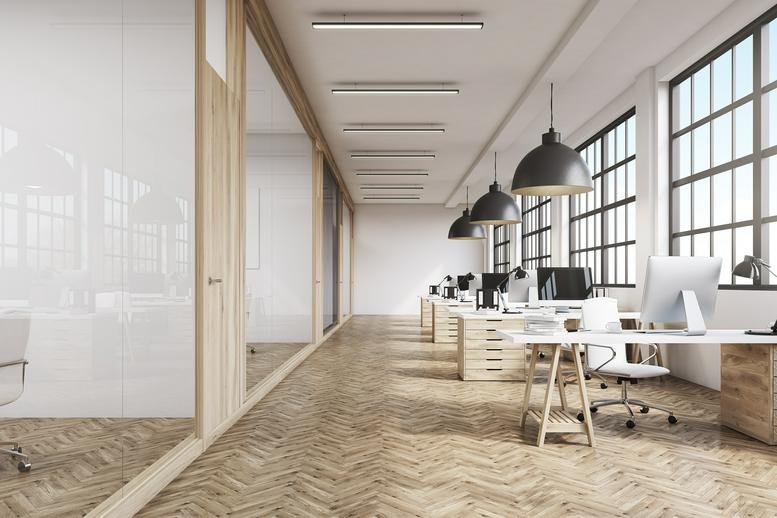 Interior workspace at 1000 Main Street, Suite 2300 featuring herringbone wood floors and black pendant lights.
