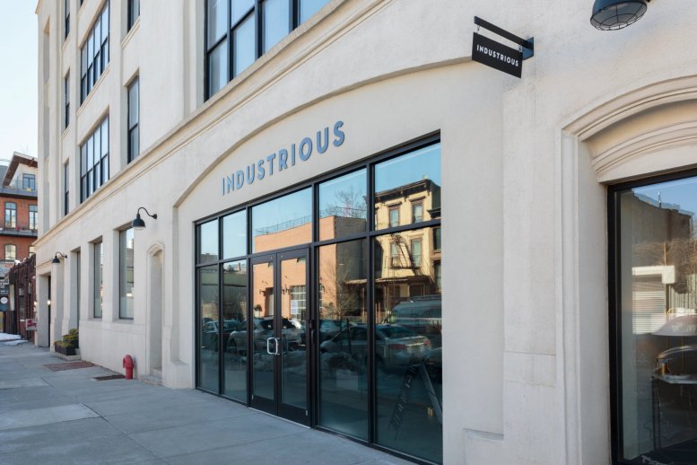 Exterior view of the white brick building facade at 1002 Dean Street.