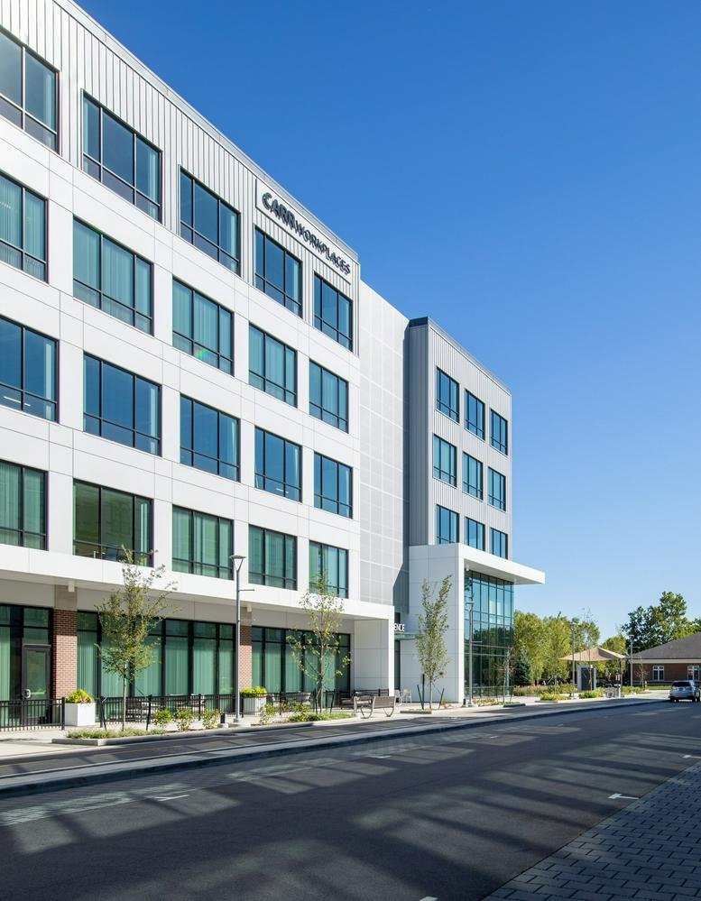 Exterior view of the contemporary white and grey facade at 101 Foundry Drive, Suite 1200.