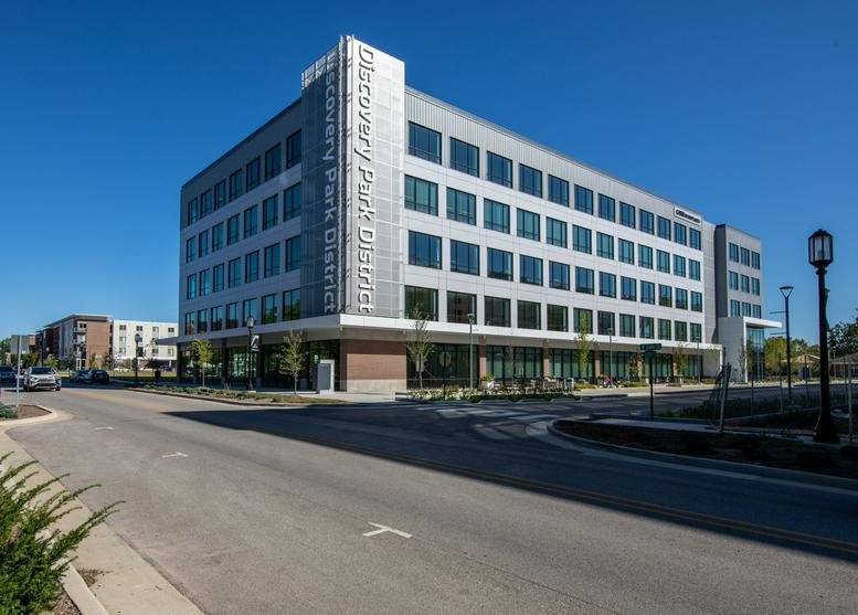 Exterior view of the Discovery Park District office building with modern glass facade.