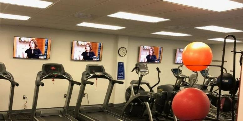Spacious gym area at 10630 Little Patuxent Parkway, Suite 314 featuring treadmills and exercise balls.