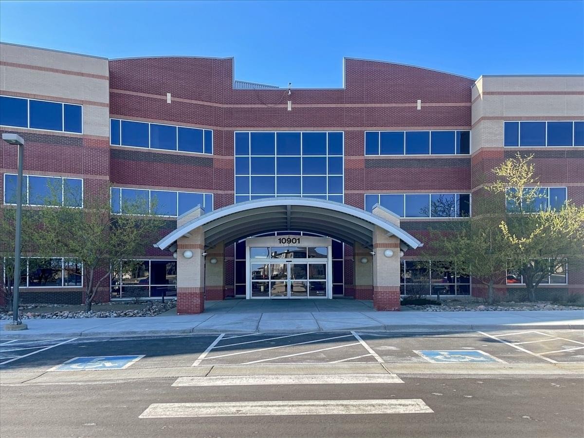 Exterior of the red brick and glass building at 10901 West Toller Drive.