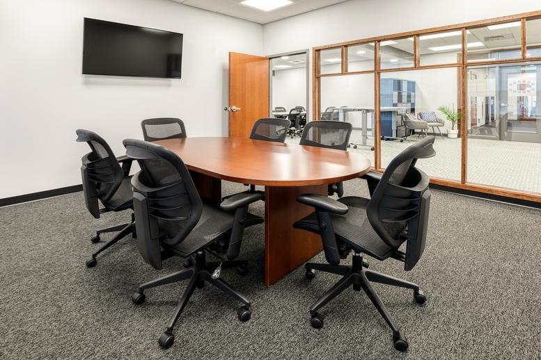 Professional conference room at 11 South Main Street, Unit 200, Concord, New Hampshire with an oval wood table.